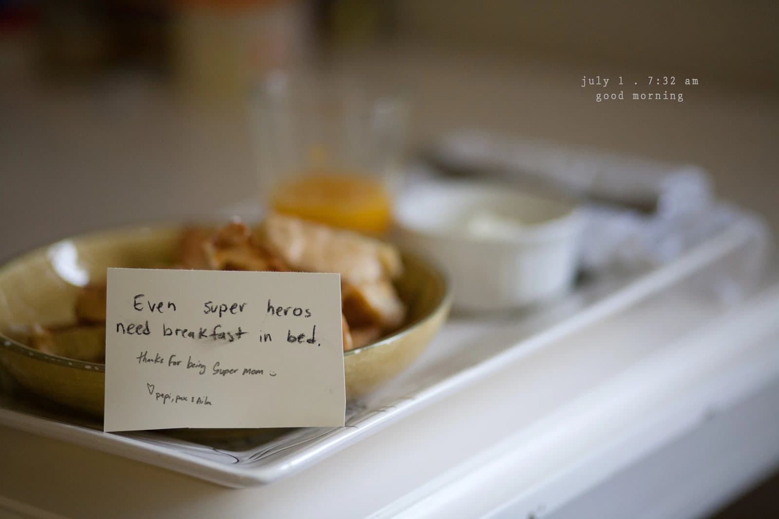 Breakfast on a tray with a note reading Even super heros need breakfast in bed.