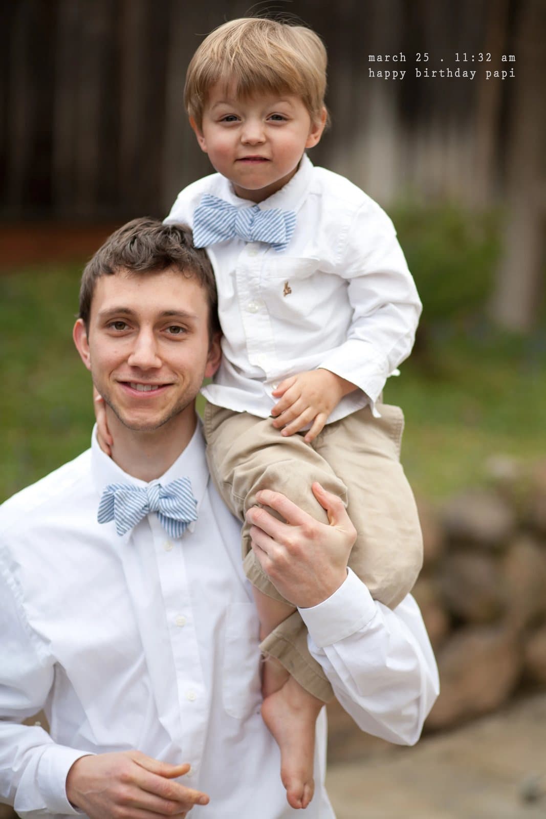 A young man in a bow tie holds a boy in a matching bow tie, captioned happy birthday papi.