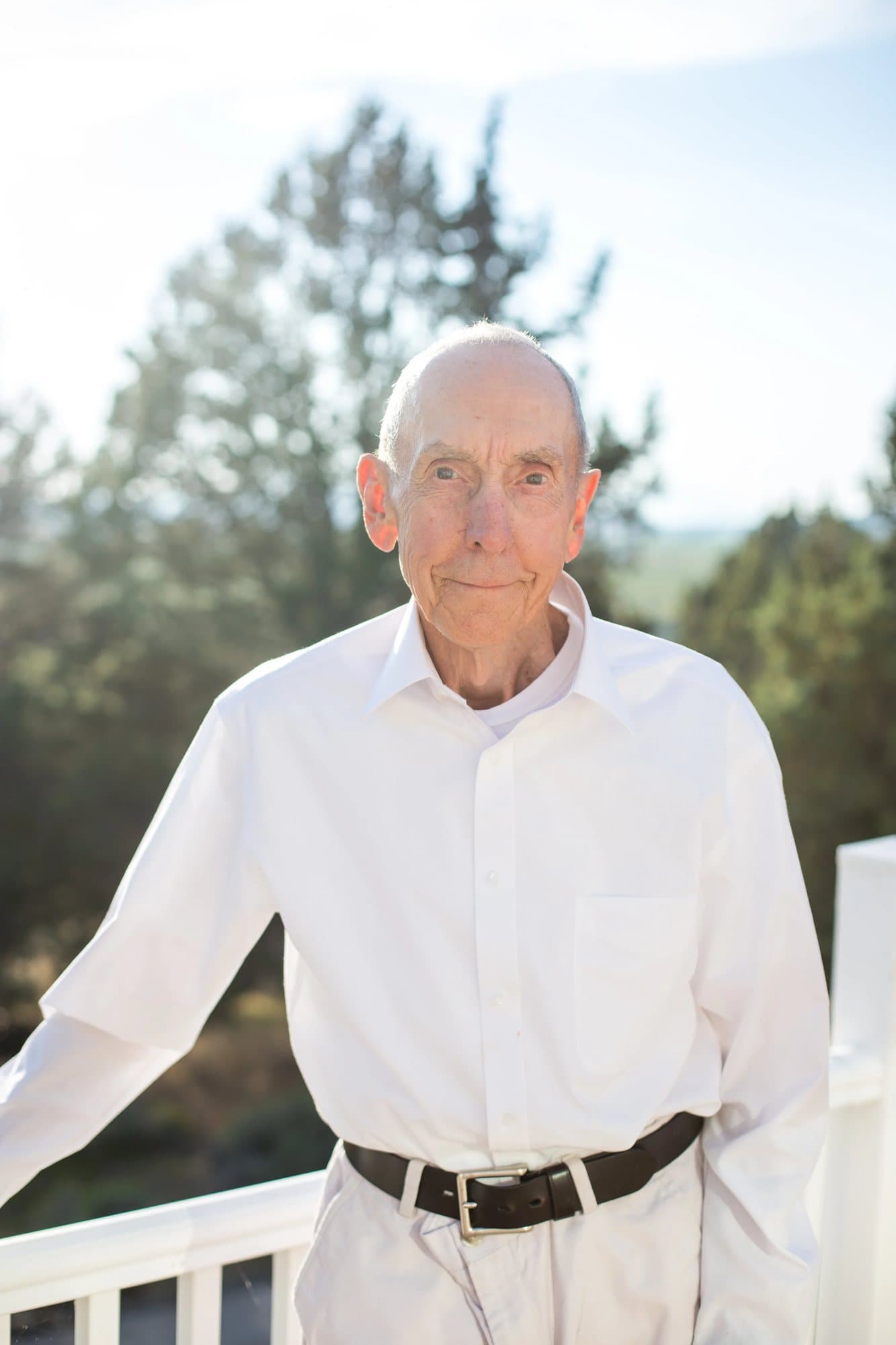 Mark's grandpa in a white shirt on a sunny porch, whose written life history inspired the magazine.