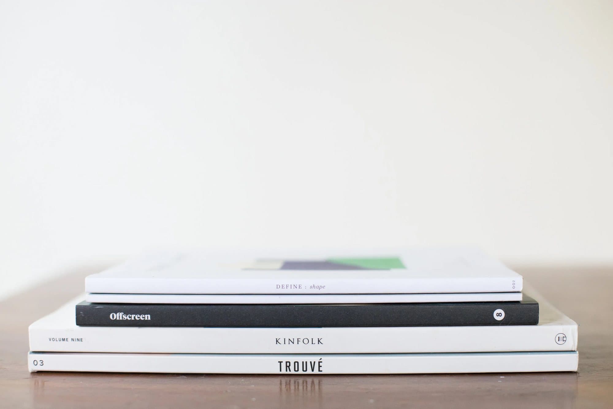 Stack of independent magazines including Kinfolk, Offscreen, Trouvé and Define, which inspired 3vies.
