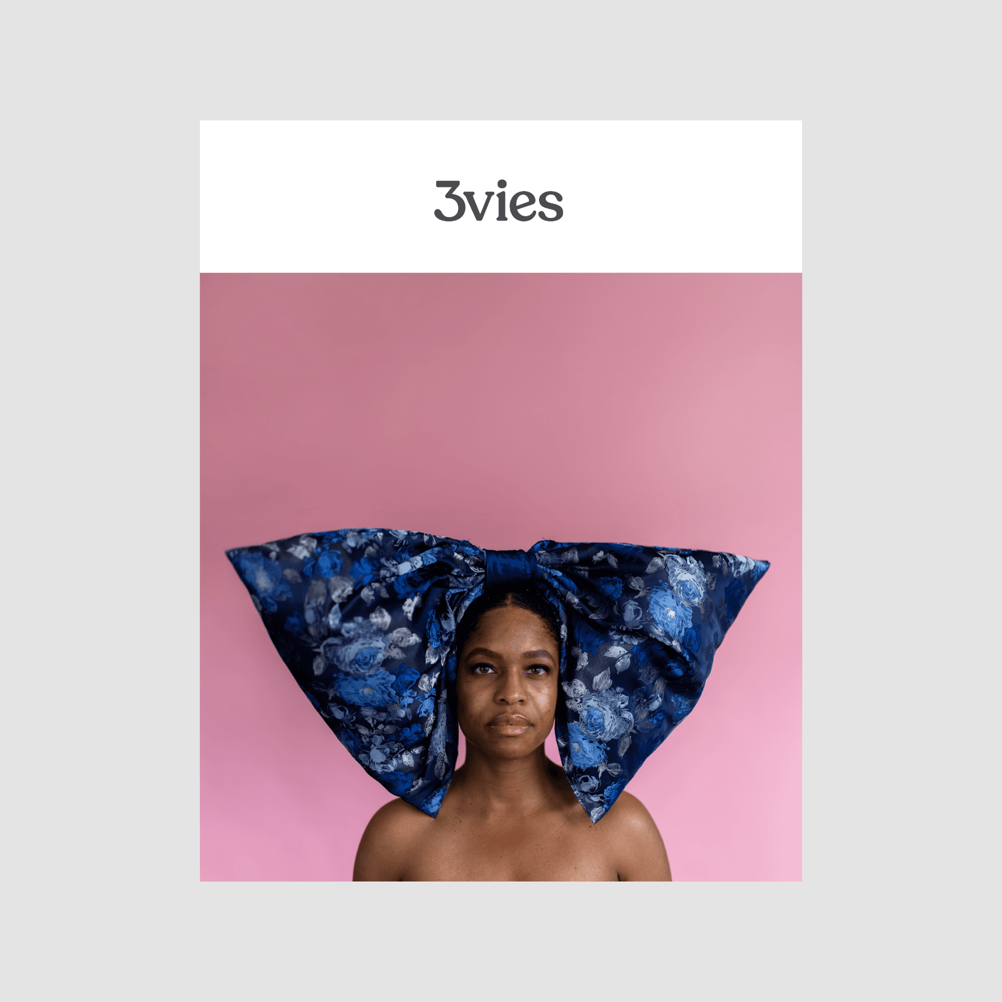 Cover of 3vies magazine Volume 39, Forward: a woman in a huge blue floral bow on pink.
