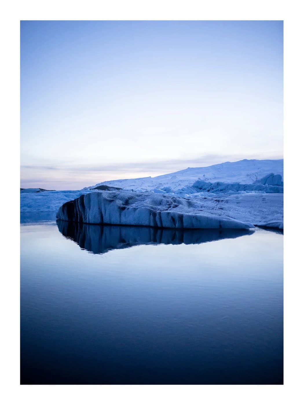 Iceland Blue Hour, a TIMELESS archival print of glacial ice reflected in still water at dusk.
