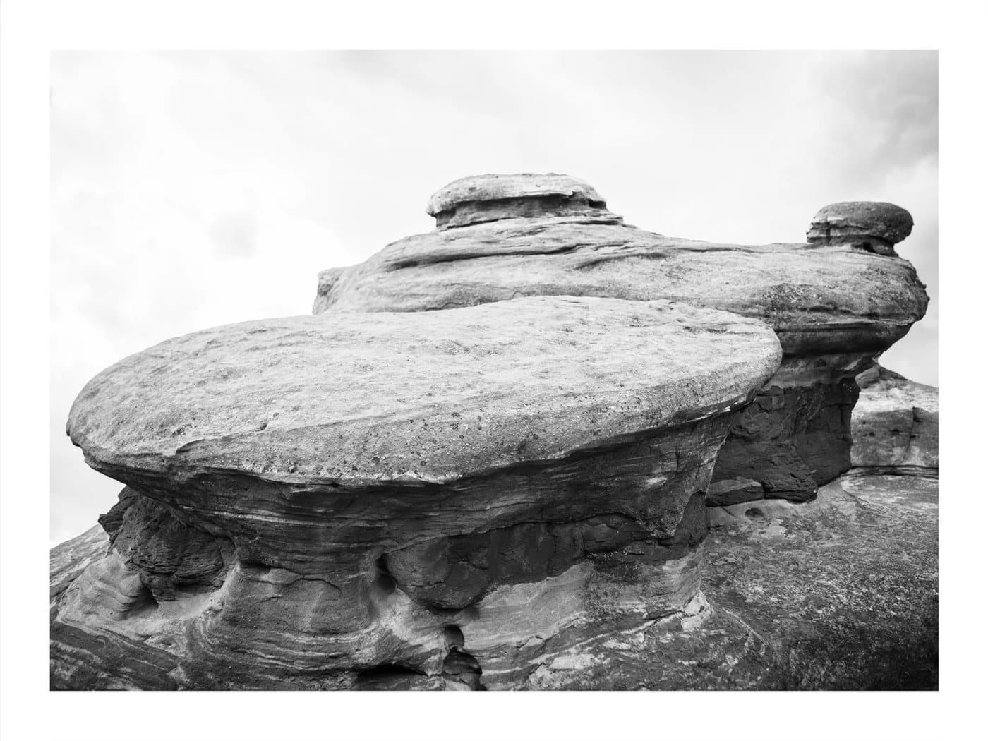 Red Rocks, a TIMELESS archival print in black and white of layered, mushroom-shaped rock formations.