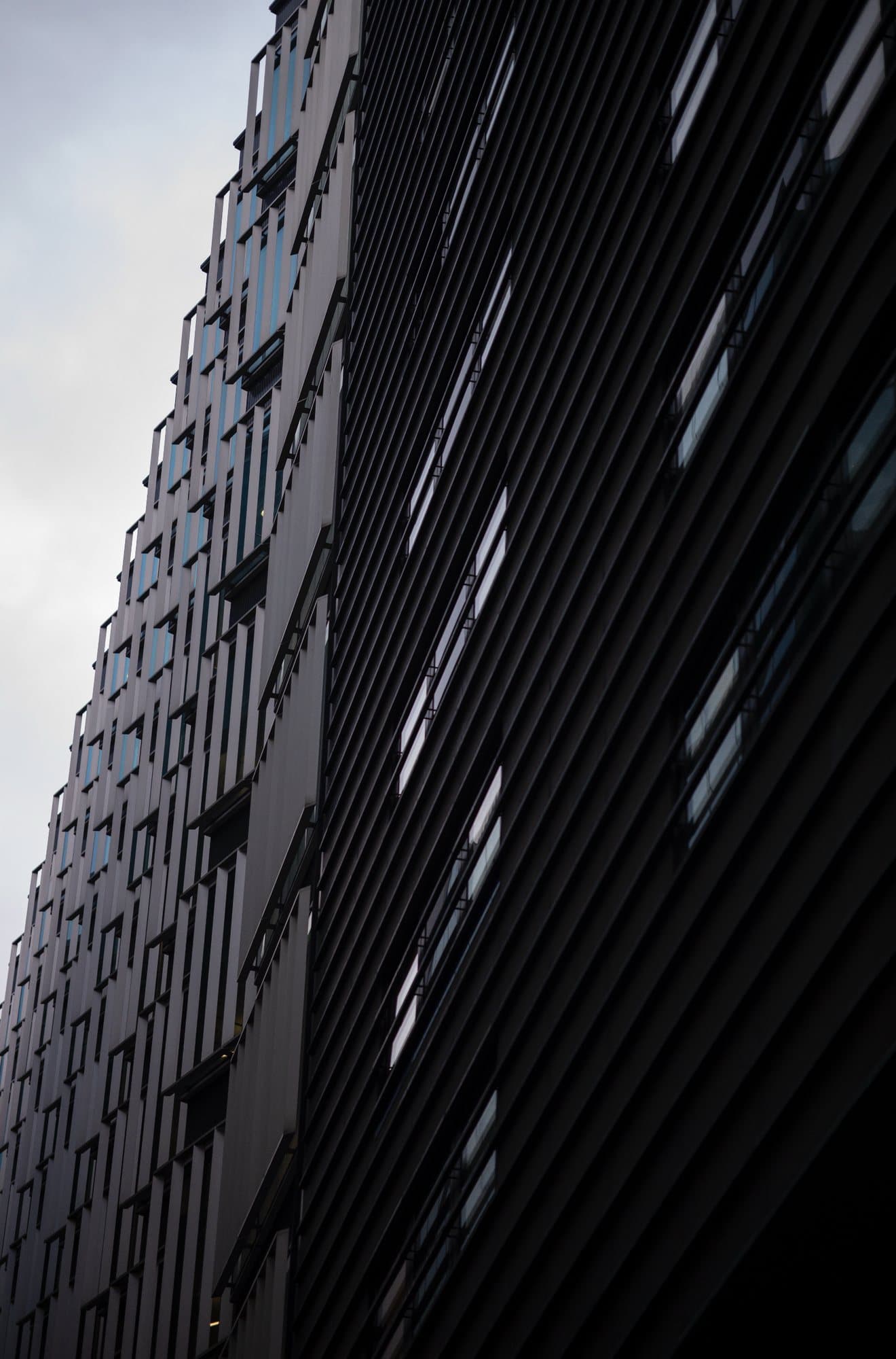 Photo handout looking up at the dark angular facade of a modern high-rise.