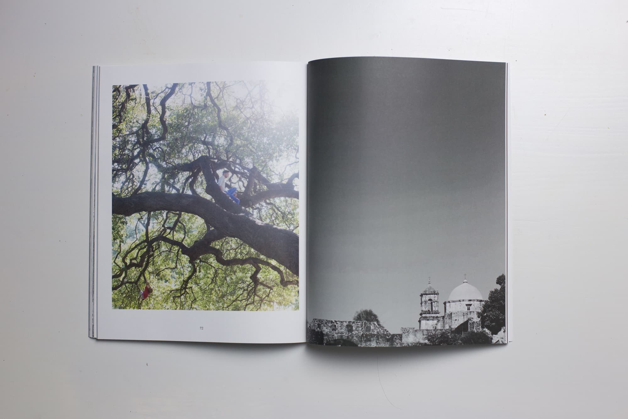 An open spread from the first 3vies volume: a child climbing a wide oak on the left page, a mission church in black and white on the right.