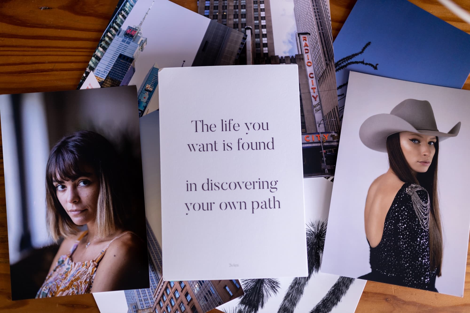 Magazine pages spread on a table: two portraits beside a page reading The life you want is found in discovering your own path.